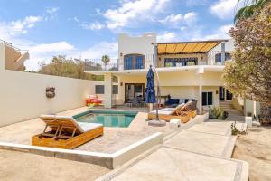 a home with a swimming pool and a house at Casa Reyes -All in One, Heated Pool & Beach Access in El Pueblito