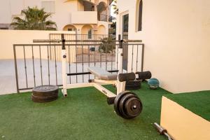 a home gym with dumbbells on the grass at Casa Reyes -All in One, Heated Pool & Beach Access in El Pueblito