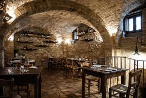 a restaurant with tables and chairs in a brick room at BB Maltagliati in Torano Nuovo
