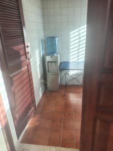 a small kitchen with a table and a tiled floor at Double room with private bathroom in Santo Domingo