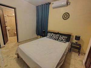 a bedroom with a bed and a window and a fan at Double room with private bathroom in Santo Domingo