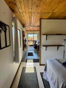 a bedroom with a bed and a wooden ceiling at BeMyGuest Floripa in Florianópolis