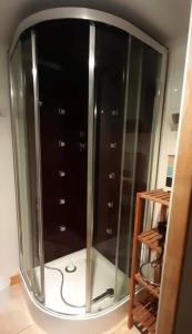 a large mirror in a room with some hangers at Le bon coin en Baie de Somme in Boismont