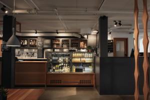 a bar in a restaurant with a counter at Home Hotel Magasinet in Trelleborg
