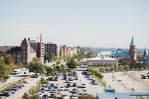 a city street filled with parked cars in a parking lot at Home Hotel Magasinet in Trelleborg