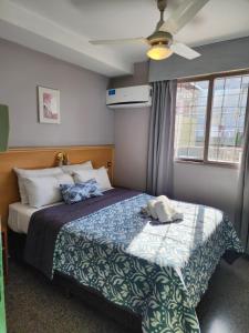 a bedroom with a bed and a ceiling fan at Hotel JBJ in Mendoza