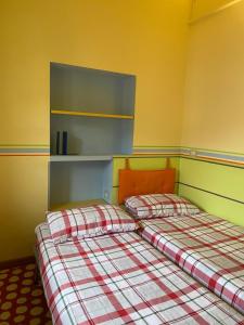 two beds sitting next to each other in a room at Landi House in Uzzano