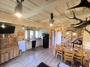a kitchen and dining room with a table and chairs at Domek Góralsko Gawra in Murzasichle