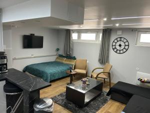 a small living room with a bed and a couch at Appartement Agréable Robertsau in Strasbourg