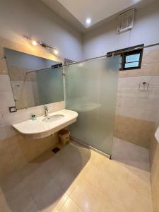 a bathroom with a sink and a shower at Margalla Residency Islamabad in Islamabad