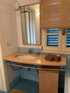 a bathroom with a sink and a mirror at Landi House in Uzzano +2 photos