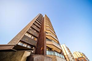 a tall building with a blue sky in the background at Hotel Prinz - PRZ000 in Joinville