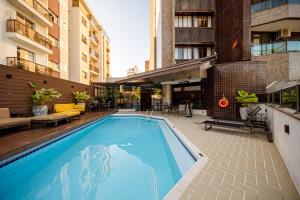 a swimming pool on the side of a building at Hotel Prinz - PRZ000 in Joinville