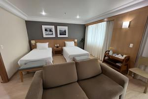 a living room with two beds and a couch at Mediterrâneo Flat in Rio de Janeiro +166 photos