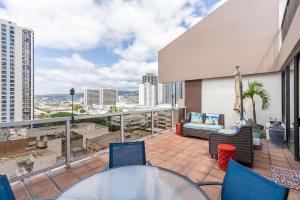 a patio with a table and chairs on a balcony at Executive Centre 1120 in Honolulu