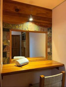 a mirror on top of a wooden counter in a room at HOTEl CHAIS in Colorines