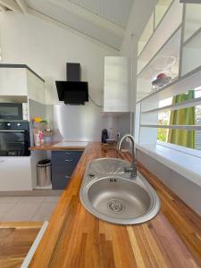 Kanel' Kaz - Jacuzzi & Vue mer في كابستر-بيل-أو: مطبخ مع حوض في وسط كونتر