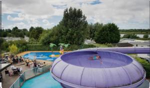 a large swimming pool with people in a pool at Marton Mere 8 Berth Caravan in Blackpool +8 photos