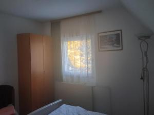 a bedroom with a bed and a window at Gostišče Jelka, Hočko Pohorje in Pohorje