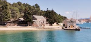 a group of buildings on the shore of a body of water at Adriatic Lifestyle Apartment in Stari Grad