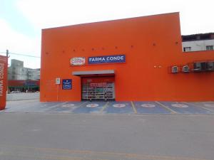 an orange building with a book store on the street at Pink house Enseada Beach in Guarujá