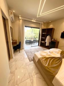a bedroom with a bed and a view of a patio at Glamour Pyramids BoutiQue Hotel in Cairo