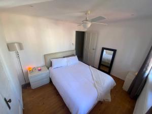 a bedroom with a white bed and a ceiling at Exclusive Master Bedroom Room with Broadwater views in Gold Coast