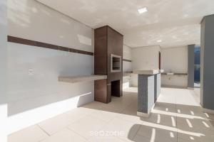 a kitchen with white walls and a counter top at Apartamentos próx. da praia do Mutá/BA - RFMs in Coroa Vermelha