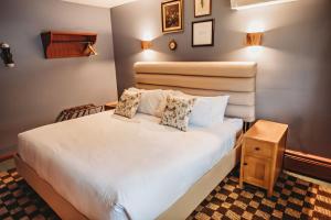 a bedroom with a large white bed in a room at Hideaway Inn Mt Snow in Dover