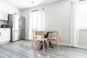 a kitchen with a table and chairs and a refrigerator at The Vibe on Durham IX 8786 in Durham