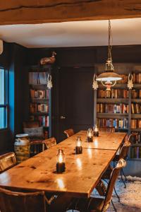 a large wooden table in a room with books at Hideaway Inn Mt Snow in Dover