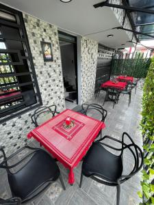 a red table and chairs on a patio at Hotel boutique Olaya 54 in Medellín