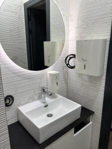 un bagno con un lavandino bianco e uno specchio di Magnet Lux Zlatibor 
