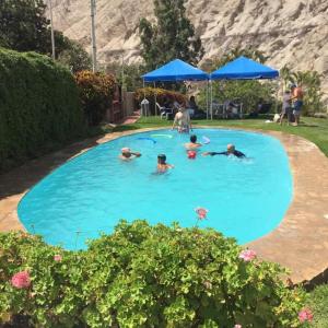 un gruppo di persone che nuotano in una piscina di San Jerónimo River Lodge a Lunahuaná