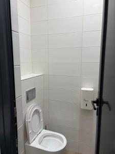 a bathroom with a white toilet in a stall at Magnet Lux Zlatibor in Zlatibor