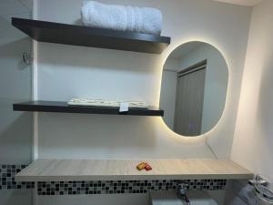 a bathroom with a mirror and a sink at Hotel boutique Olaya 54 in Medellín +42 photos