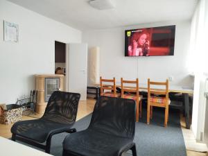 a living room with a dining room table and chairs at Harmónia 2 in Mýto pod Ďumbierom