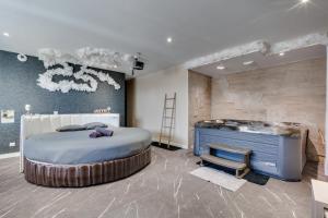 a bedroom with a large bed and a wooden wall at Loft Paradis ~Jacuzzi privatif~ Séjour amour in Vieille-Toulouse