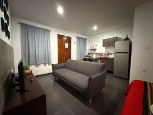 a living room with a couch and a refrigerator at Lofts de Mexiamora in Guanajuato