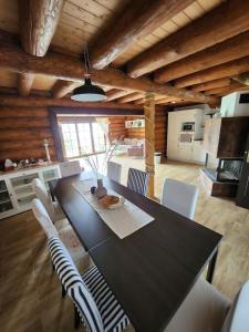 a dining room with a black table and white chairs at Zrub JESPER in Liptovský Trnovec