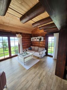 a living room with a couch and a table at Zrub JESPER in Liptovský Trnovec +61 photos