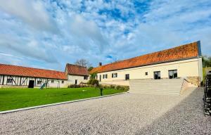 a large white building with a red roof at Domaine de la Vacquerie in Alette