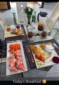 two plates of food on a glass table at CROOКED TREE LODGE Belize in Crooked Tree