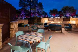 a patio with a table and chairs at night at Best Western El Paso Airport Entrada Hotel in El Paso