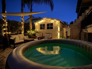 a swimming pool in a backyard at night with lights at Mood's Home in Avola