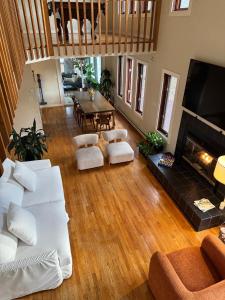 a living room with white furniture and a fireplace at Poconos Chalet -Kayaks- HotTub-Karaoke-Lake in East Stroudsburg +59 photos