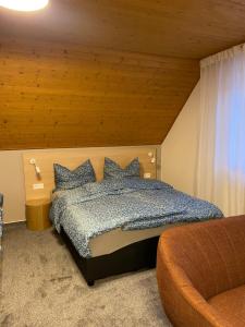 a bedroom with a bed with a wooden ceiling at Apartmány U Dvořáků in Janske Lazne