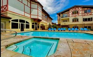 a swimming pool in front of a building at Zermatt Double Queen Suite Near Park City - 3074 in Mound City