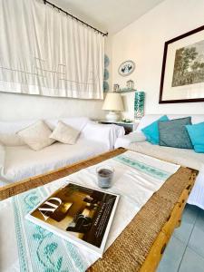 a living room with a couch and a coffee table at Amazing view apartment in Porto Rotondo +63 photos