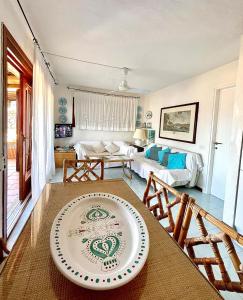a living room with a table with a plate on it at Amazing view apartment in Porto Rotondo
